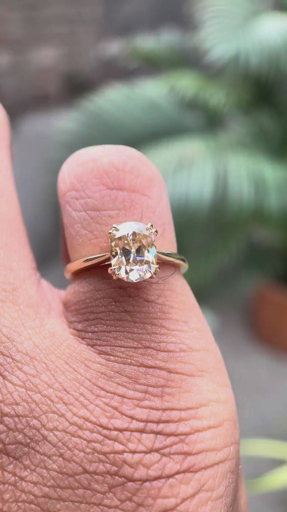 Close-up rotation highlighting cathedral setting and champagne moissanite