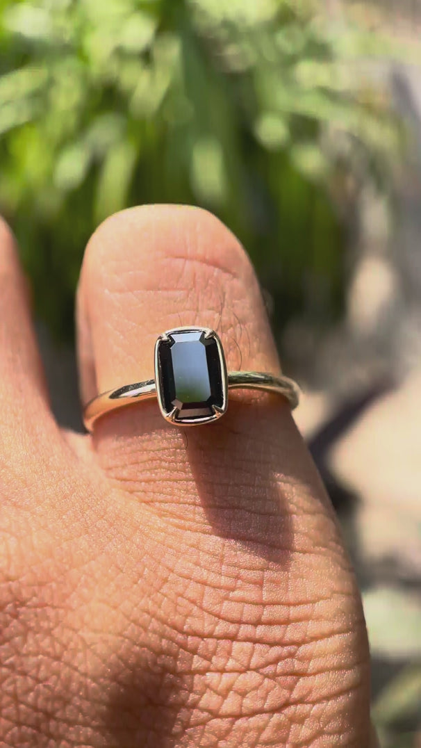 Video showcasing the solitaire emerald cut black green moissanite ring