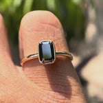 Video showcasing the solitaire emerald cut black green moissanite ring