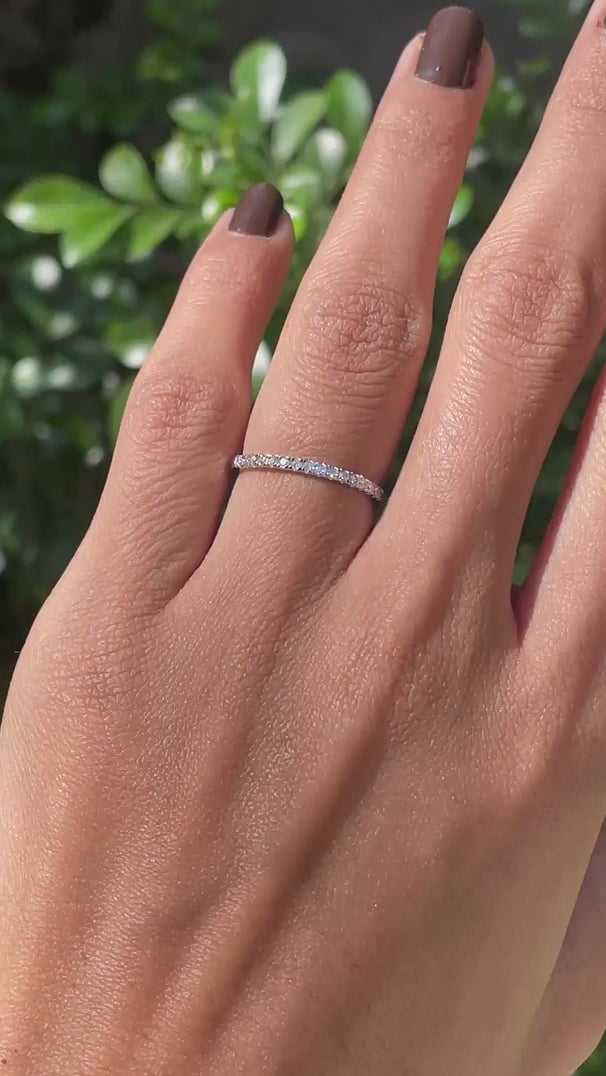 Rotating video of minimalist pave set dainty wedding band showing sparkle and slim design