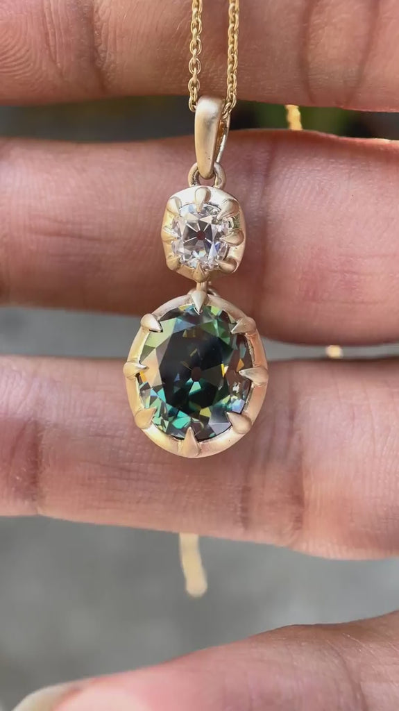 Antique style vertical dangling moissanite pendant front view video