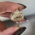 Close rotating view elongated champagne cushion moissanite three stone ring