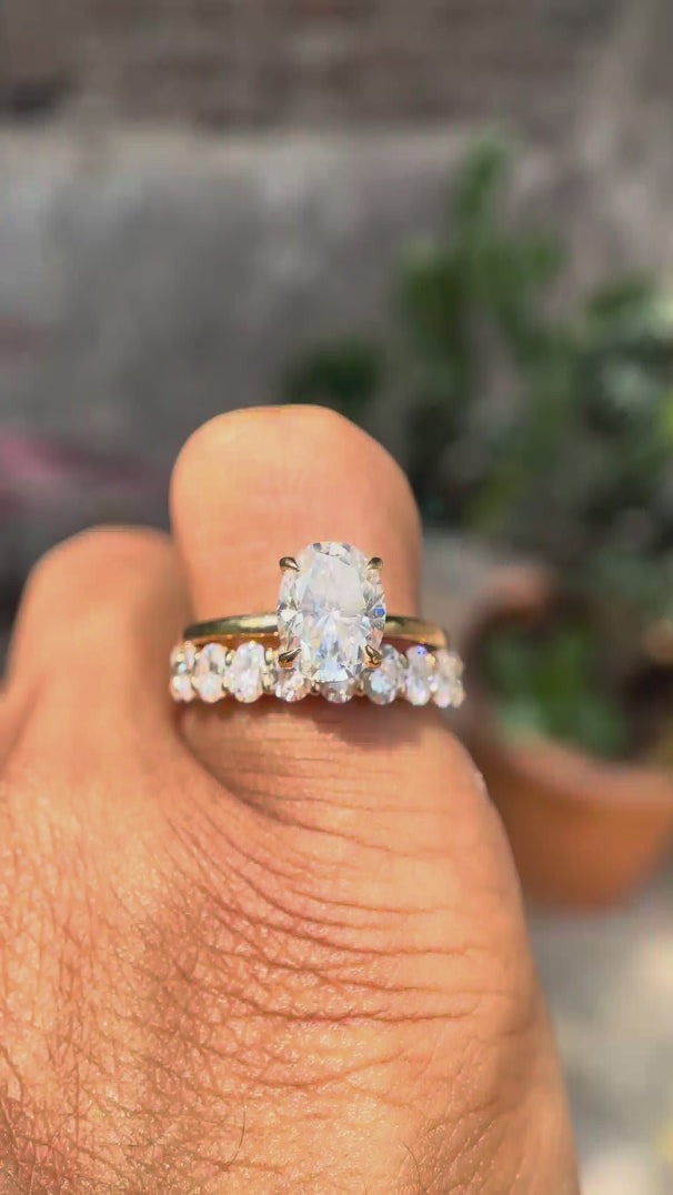 Rotating video showing oval moissanite solitaire with stack band