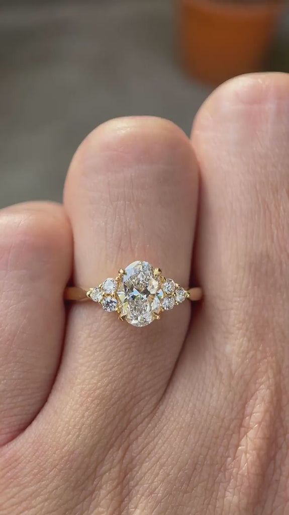 Oval lab grown diamond cluster engagement ring in 14K yellow gold shown from multiple angles