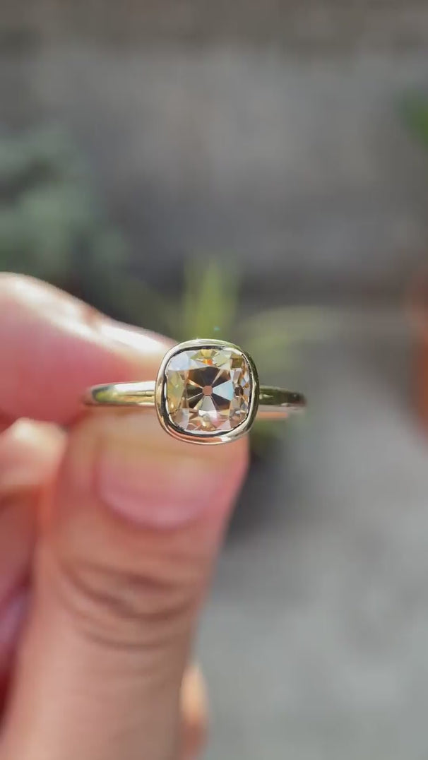 Moissanite Light Champagne Old Mine Cut bezel set solitaire ring in 10K yellow gold