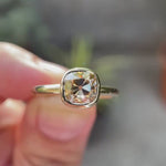 Moissanite Light Champagne Old Mine Cut bezel set solitaire ring in 10K yellow gold