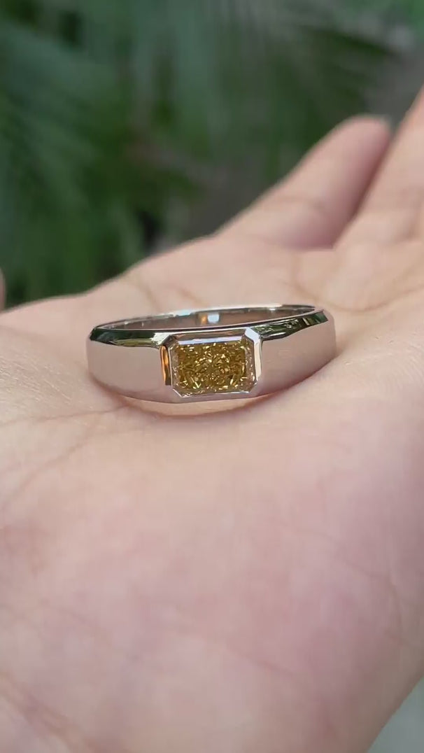 Close detail view highlighting radiant yellow diamond signet setting.