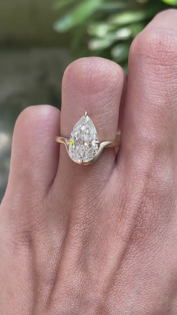 Rotating view old mine cut pear moissanite bypass engagement ring