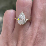 Rotating view old mine cut pear moissanite bypass engagement ring
