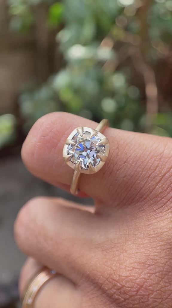 Video showcasing the Square Cushion Old Mine Cut GHI Moissanite Solitaire Bezel Set Engagement Ring in 10K Yellow Gold