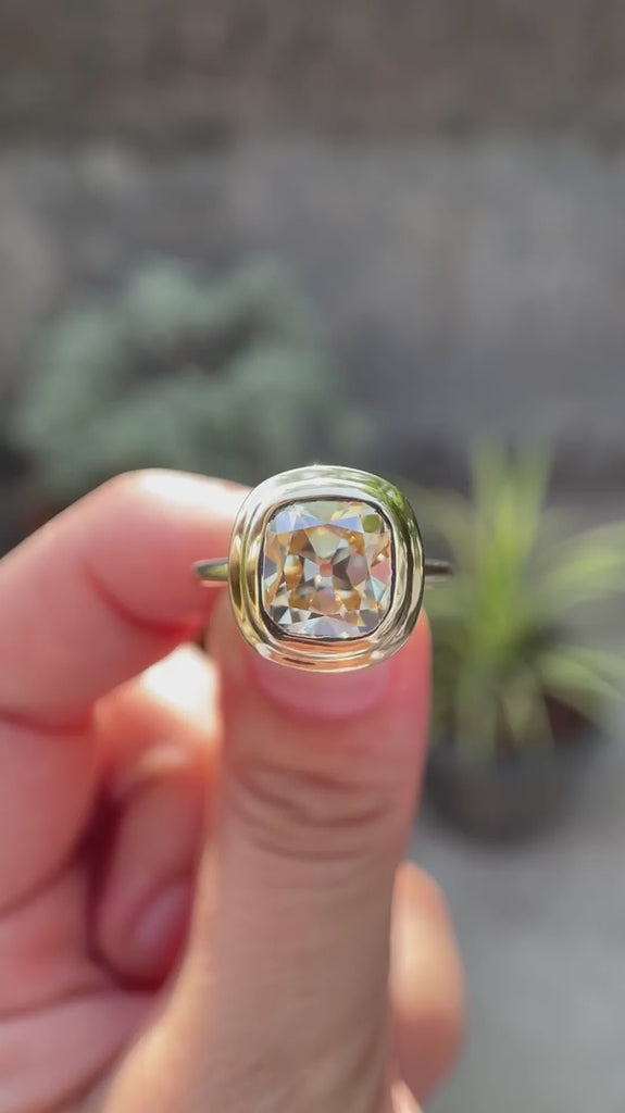 Moissanite elongated cushion engagement ring, light champagne, showcased in a high-polish 10K yellow gold setting, detailed from multiple angles