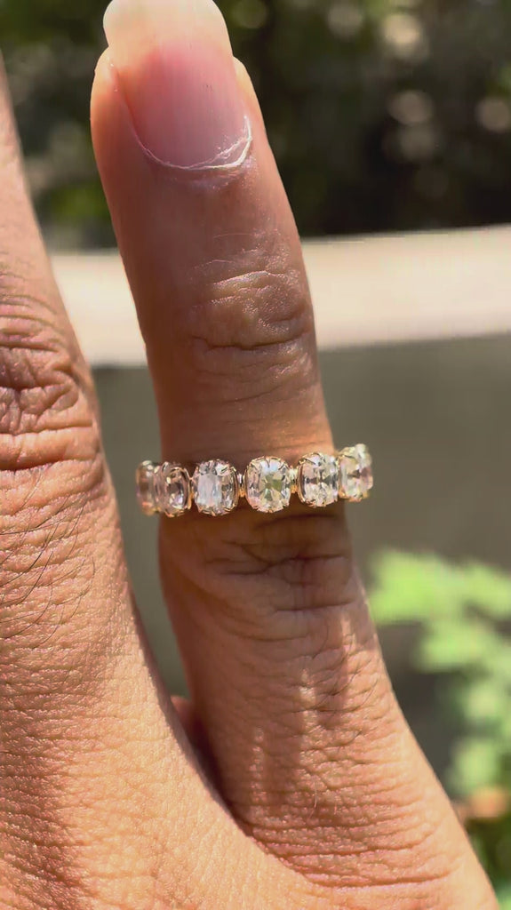 Rotating view of worn on finger elegant seven stone band highlight uniform brilliance