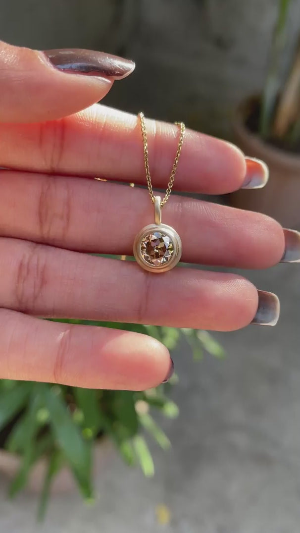 Round cut light champagne moissanite pendant yellow gold brushed matte finish