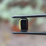 Black green emerald cut moissanite step cut Old Mine rotating view showing deep color and reflective facets