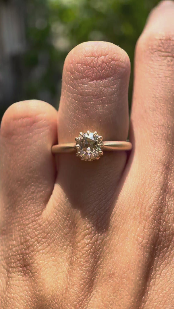 Elongated cushion Old Mine Cut light champagne moissanite solitaire ring in 10K yellow gold rotating view