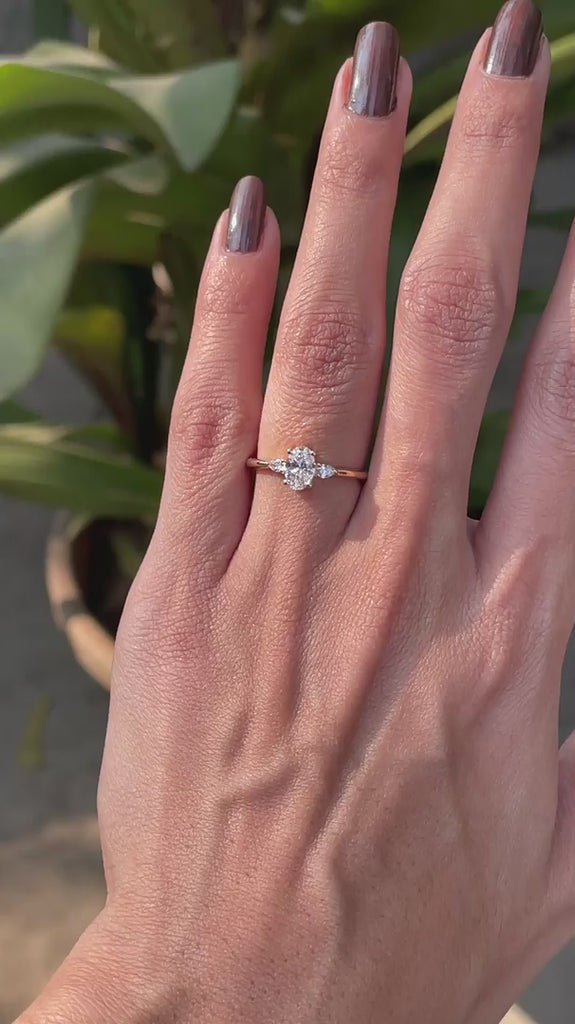 Minimalist oval diamond engagement ring with pear side stones video