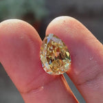 Pear Old Mine Cut Yellowish Moissanite showing brilliance and facet movement in natural light