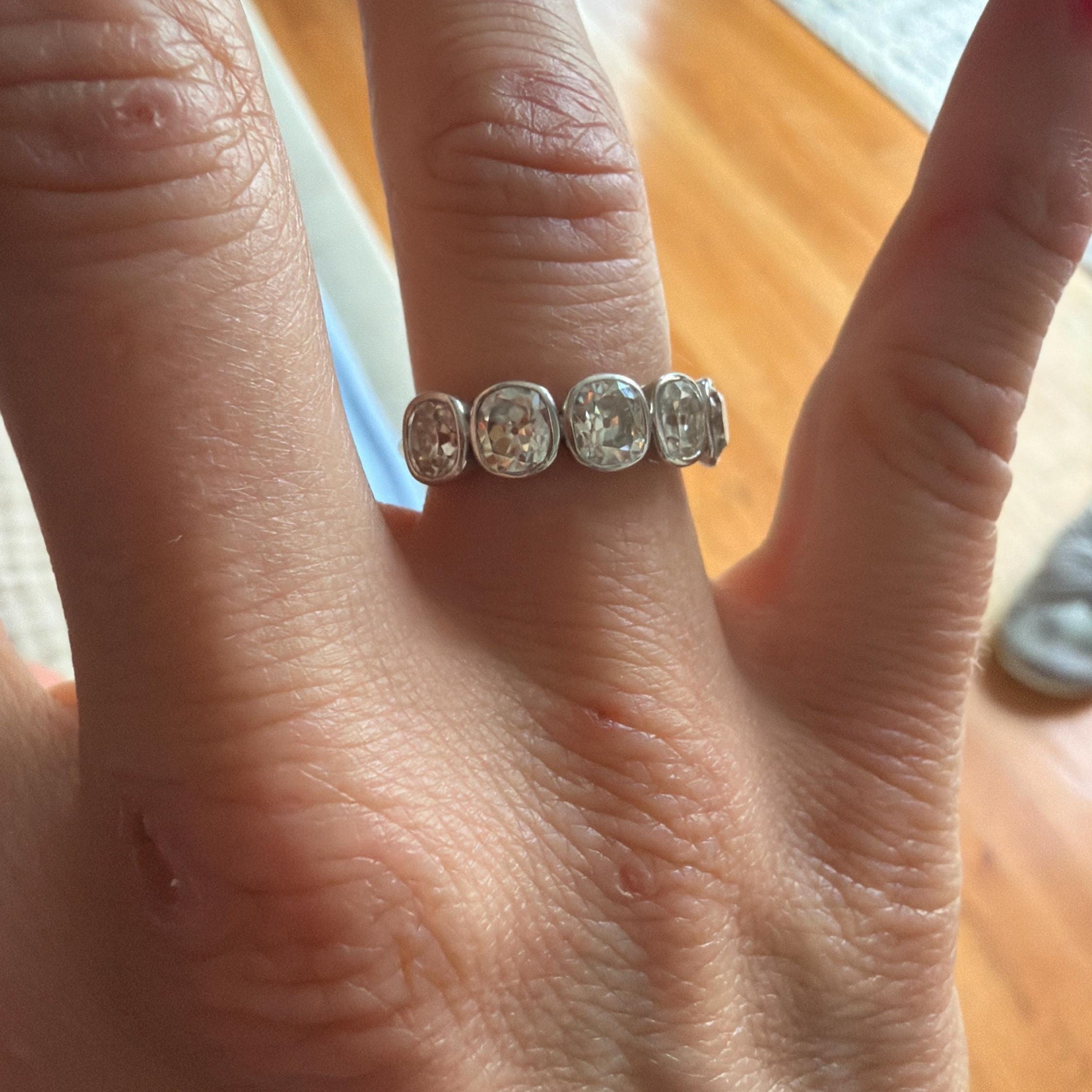 Customer photo of an Orbion moissanite wedding band, reviewed by Aviva on Etsy