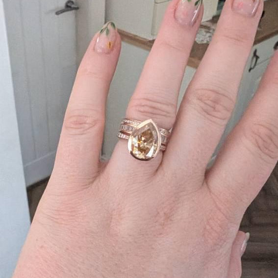 Customer photo of a custom Orbion pear bezel engagement ring in rose gold, reviewed by Gypsy on Etsy